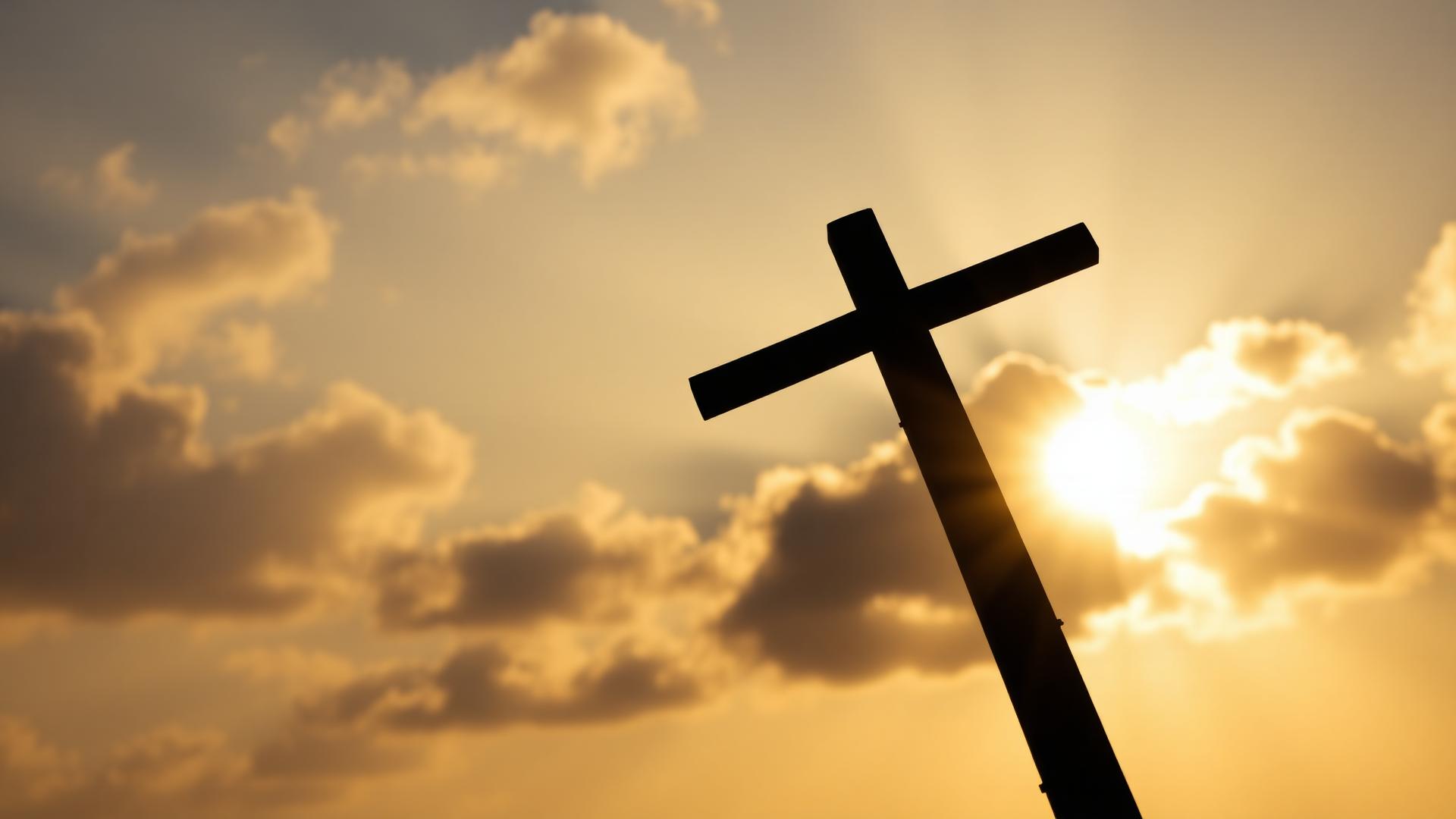 Cross silhouette against a golden sky